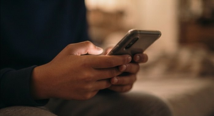 Close view of a child's hands holding a phone.